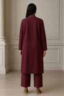 Rear view of model in 3 Piece Sweater Set with long coat and pants in elegant setting