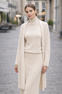 Woman wearing beige 3 Piece Sweater Skirt Set with a long cardigan and turtleneck, perfect for sophisticated and stylish looks.