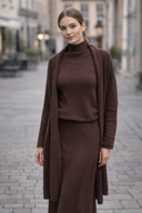 Model wearing a brown 3 Piece Sweater Skirt Set with bell sleeves and drawstring waistband, perfect for adding sophistication to any outfit.