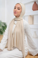 Woman wearing Beige Jersey Hijab with Undercap, showcasing lightweight drape in a soft, staple color ideal for effortless styling.