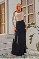 Woman in orange hijab wearing black satin maxi skirt