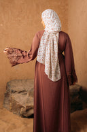 Woman in brown dress and floral hijab wearing purple lace sleeve abaya